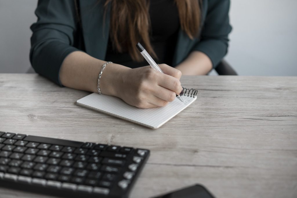 woman writing in notebook